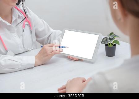 doctor showing blank tablet screen to patient representing healthcare application mockup and digital medical interface Stock Photo