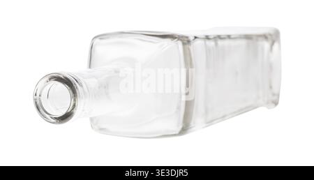 Overturned empty clear wine bottle against white background Stock Photo