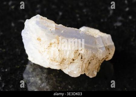 Sample of rough blue agate rock on black granite background from close-up from Uzbekistan Stock Photo