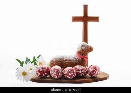 Easter lamb cake with decorated eggs and wooden cross Stock Photo