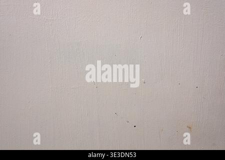 Close-up of textured beige surface with subtle speckles and small dark spots. Minimalist abstract background suitable for design or architectural proj Stock Photo