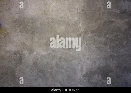Textured gray concrete surface with subtle speckles and uneven lighting. Ideal for backgrounds in design, architecture, or industrial projects. Neutra Stock Photo