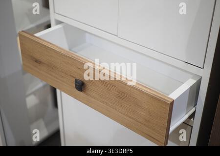 Wooden drawer is open in a modern cabinet design Stock Photo