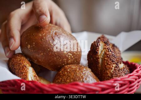 Freshly baked bread rolls in a red basket Stock Photo