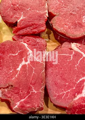 Close up view of filet mignon steaks on display on a market stall. No people. Stock Photo