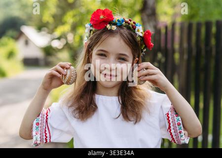 Girl holding handmade Easter eggs decorated with traditional folk techniques in Slovakia. Stock Photo