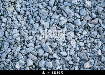 Crushed grey stone texture with various sizes of sharp-edged granite rocks. Detailed natural background pattern for construction, landscaping, and ind Stock Photo