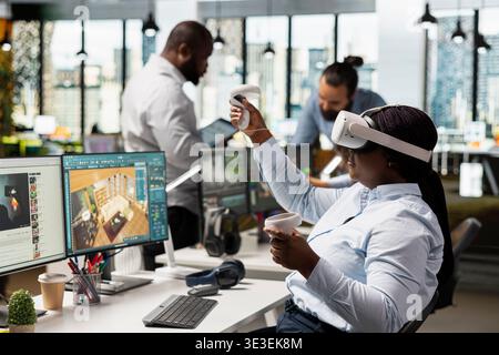 Woman engineer developing architectural layout with VR gadgets, designing layout in cyberspace using modern CAD software. Employee creates 3D modeling assets, interior design renderings. Stock Photo