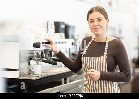Woman barista making coffee Stock Photo