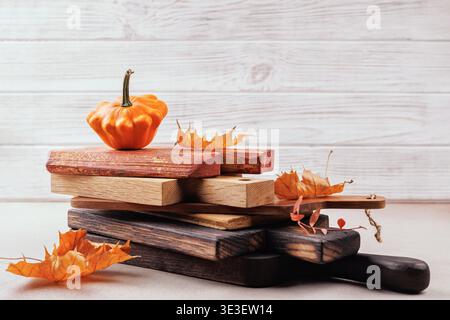 Rustic thanksgiving concept with pumpkin and cutting boards Stock Photo