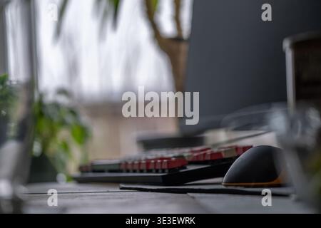 Computer keyboard and mouse on desk in modern workspace with soft natural light and shallow depth of field. Clean setup representing productivity and Stock Photo