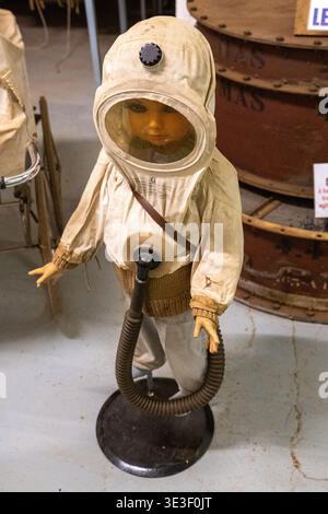 Veckring, France - 3 Mar 24: Mannequin wearing a vintage gas protection hood and breathing hose displayed in the Ouvrage Hackenberg Maginot Line fortr Stock Photo
