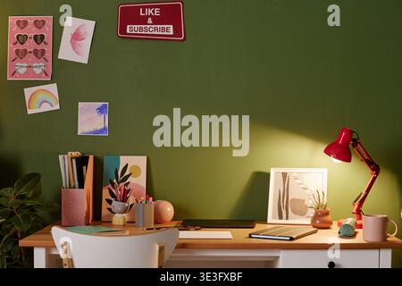 Creative Workspace Featuring Desk Lamp and Stationery on Wooden Table Stock Photo