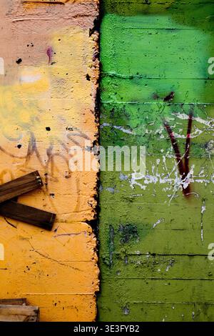 wall with old yellow and green paint Stock Photo