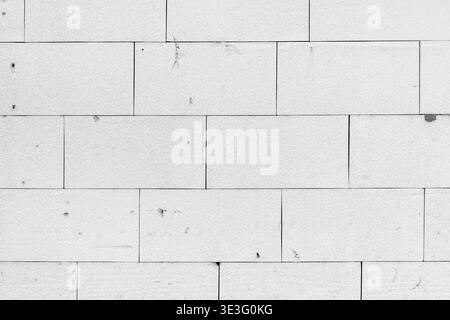 Architectural detail of white expanded polystyrene styrofoam insulation panels glued to an exterior wall in a grid pattern as background Stock Photo