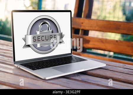 Laptop screen showing a padlock with SECURE banner on an outdoor wooden desk, symbolizing data protection and cybersecurity Stock Photo