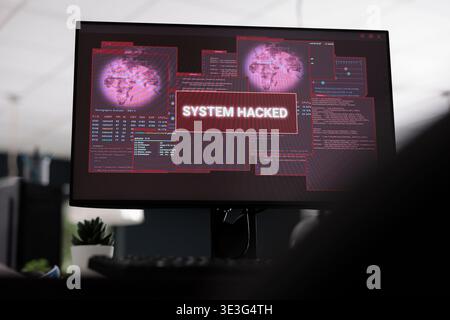 Computers displaying hacked system alert message showing on screen, flashing security breach warning. Empty software developer big data office with multiple monitors running malfunction. Close up Stock Photo