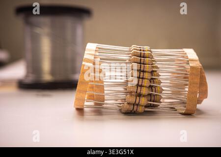 Electronic resistors in tape packaging on table, electronic components close-up Stock Photo