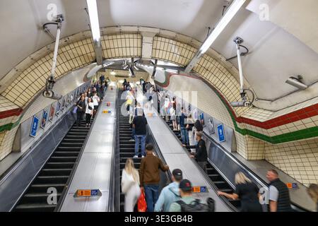 Commuters moving on busy escalator in the London Underground. London, UK, 16 July 2023 Stock Photo