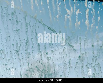 Close-up abstract texture of blue surface with water stains, streaks, and drip marks. Ideal for grunge design, artistic backgrounds, weathered surface Stock Photo