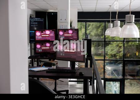 Empty office with computer monitors showing hacking warning alert after security breach, cyber crime attack with error distortion message. Software company having pc with system crash and malfunction. Stock Photo