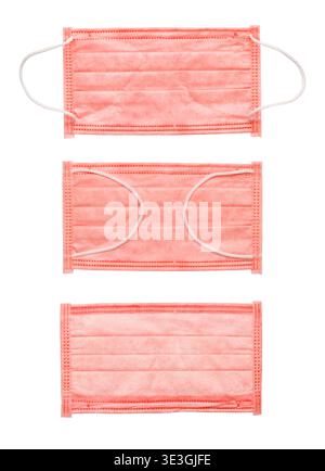 Composition of pink surgical masks in various positions isolated on white. Medical flat lay of protective face masks for women's health or fashion saf Stock Photo