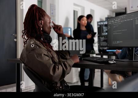 Web developer brainstorming programming ideas trying to write code and create new interface in office. Engineer working at server database in busy artificial intelligence developing agency. Stock Photo