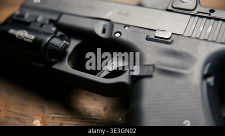 Black semi automatic handgun with tactical accessory details Stock Photo