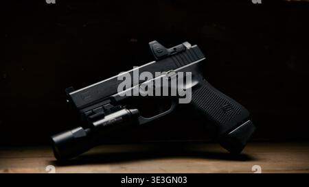Black semi automatic handgun with tactical accessory details Stock Photo