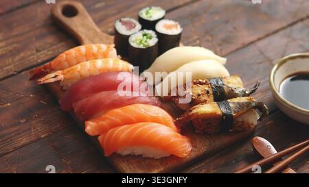 Assorted sushi set with nigiri and maki rolls on a wooden board Stock Photo