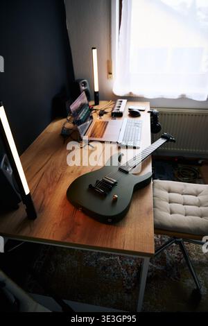 Green Electric Guitar on Wooden Desk in Home Studio Stock Photo