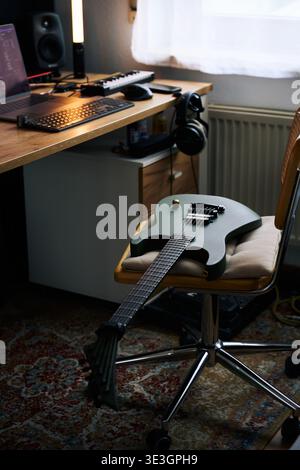 Green Electric Guitar on Wooden Desk in Home Studio Stock Photo