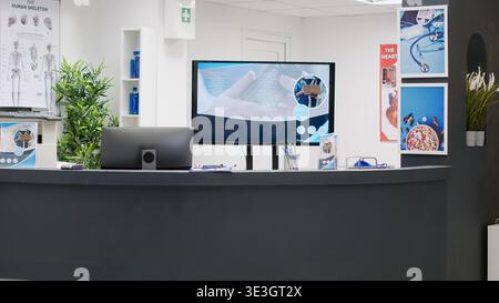 Hospital reception counter in clinic lobby to help patients and doctors with consultations and medical appointments. Empty reception desk in waiting area room, healthcare center. Stock Photo