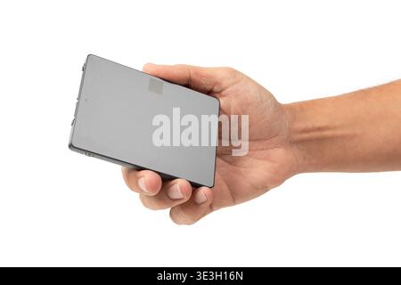 Male hand holding a Solid state drive, SSD, isolated on white background cutout Stock Photo