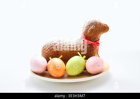 Easter lamb cake with colorful decorative eggs Stock Photo