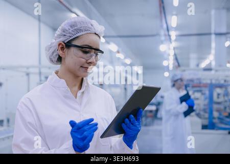 Hygiene inspector certify stuff officer work in science factory laboratory. people in pharmaceutical medicine production process inspector. Stock Photo
