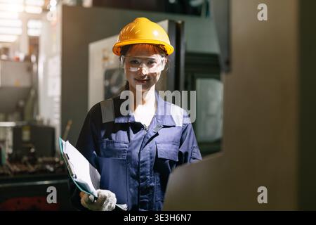 Professional young Asian Engineer woman working in heavy metal industry factory smart and confident Stock Photo