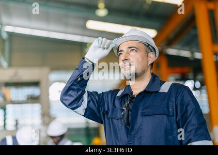Professional adult engineer male standing confident, Smart expert skillful worker happy and proud with work experience in heavy industry Stock Photo