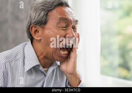 Senior Man Suffering from Toothache and Dental Pain at Home, Elder man dental painful expression Stock Photo