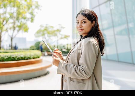 Asian Indian Business women. Fashion jacket woman smart look confident at outdoor street park. Stock Photo