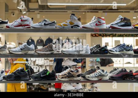 Athletic shoe shelves in a display store. Nike, Air Jordan and Asics shoe models in a modern interior. Minsk, Belarus - December 16, 2025 Stock Photo
