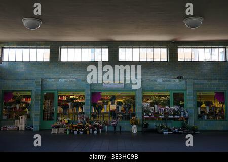 Inside Gesundbrunnen U-Bahn station, green tiled concourse with staircase, platform, information boards and retail shops, Berlin, August 2018. Stock Photo