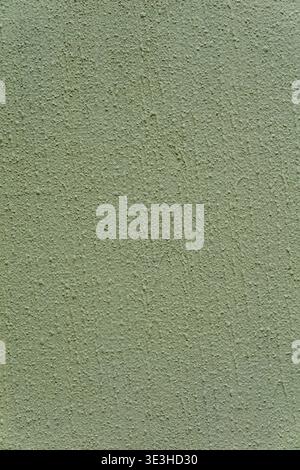 Close up of a light green stucco wall with fine grain and rough matte surface. Stock Photo