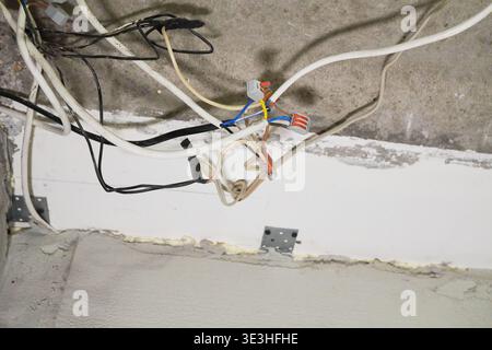 Complex Network of Electrical Wires and Cables Installed in a Domestic Ceiling Structure Stock Photo