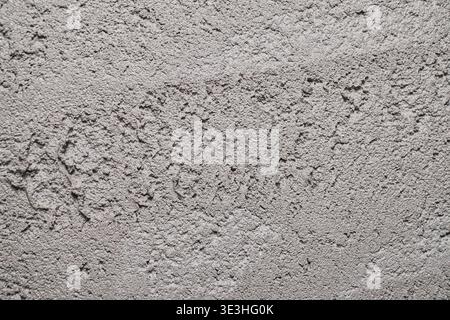 Textured Surface of Dry Cement Showing Distinct Patterns and Variations in Coloration Stock Photo