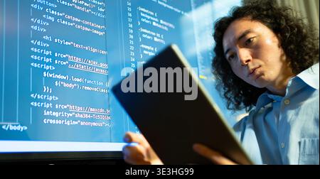 code analyst using big display, software developer focused on debugging with extensive monitor setup Stock Photo