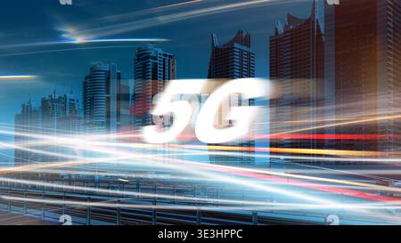 5G internet network logo over city skyline with blurred lights in fast-moving traffic Stock Photo
