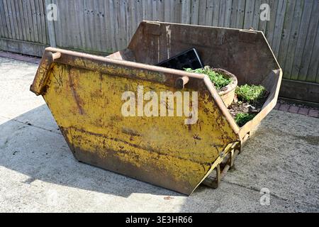 Two Yard Mini Skip containing garden rubbish. Stock Photo