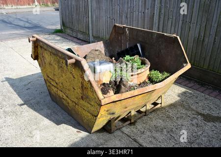 Two Yard Mini Skip containing garden rubbish. Stock Photo