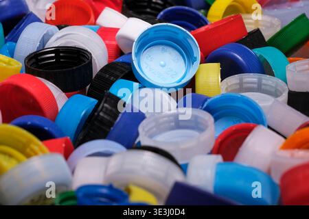 Large pile of colorful plastic bottle caps for recycling Stock Photo